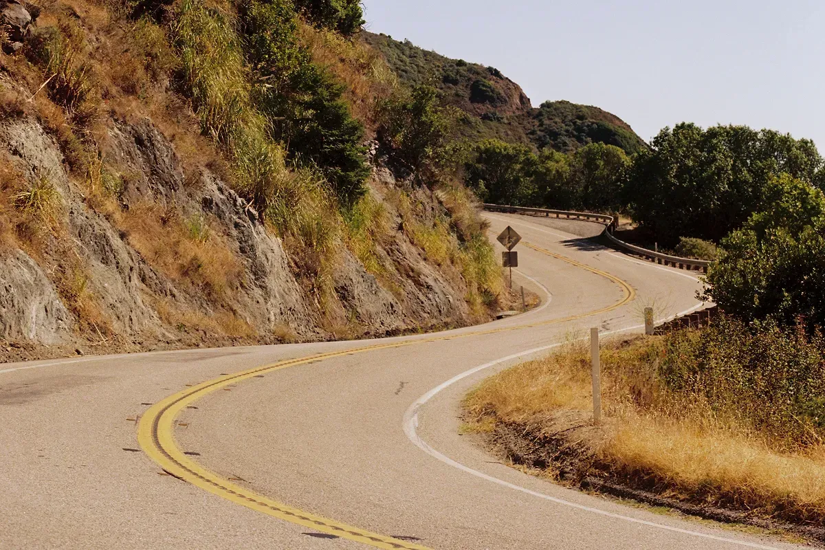 A twisty road hugging the side of a mountain